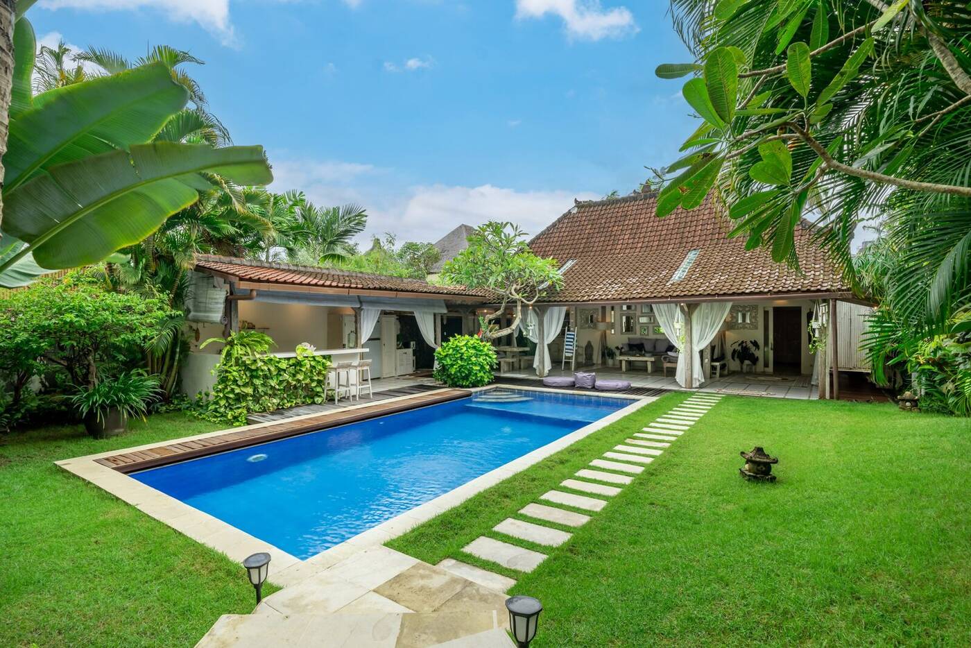 Swimming pool and Balinese Joglo roof seen from the garden, Berawa, Bali