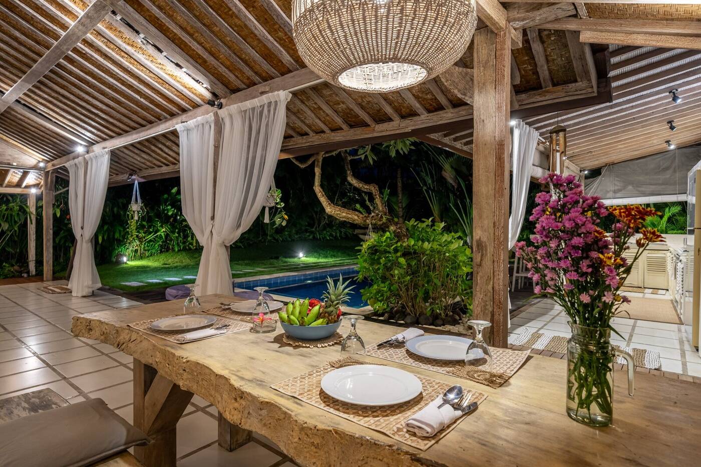 Dining table set for dinner overlooking the pool, Canggu, Bali