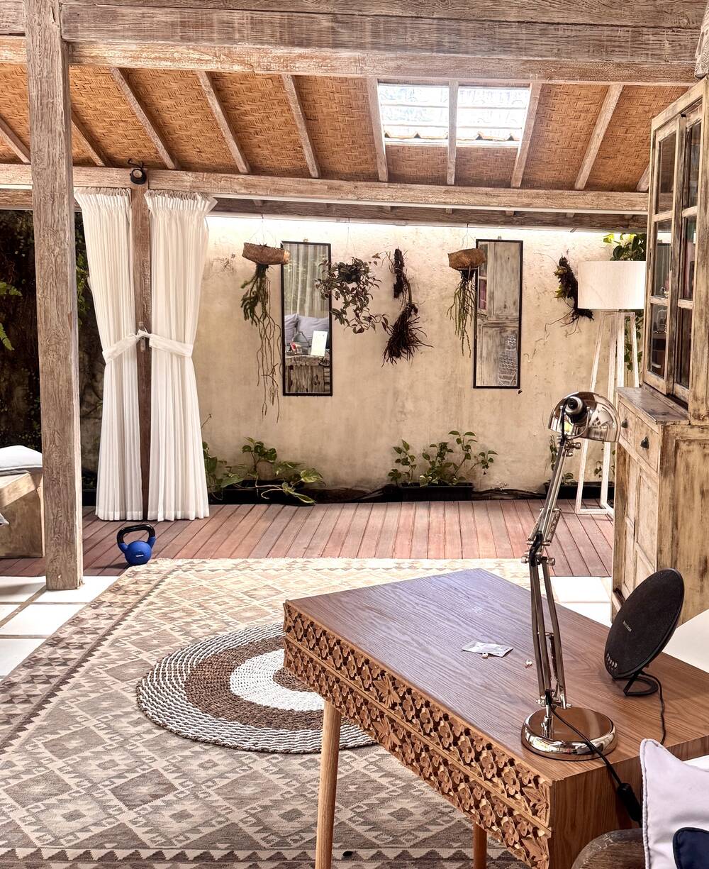 Carved teak desk with desk lamp for remote work, villa in Berawa, Bali