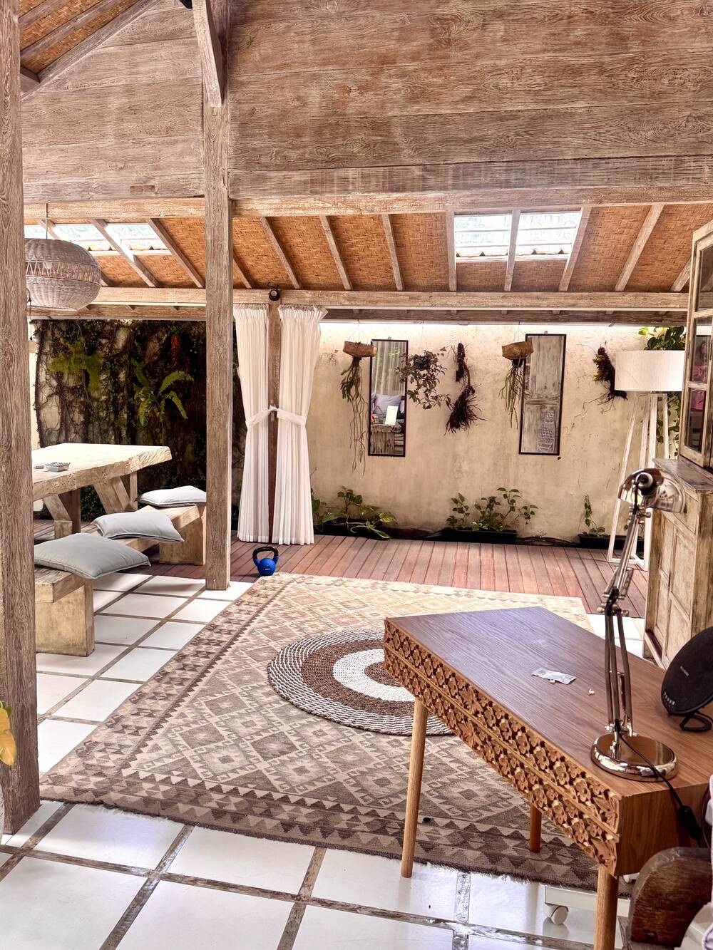 Desk, chair and large rug under the wooden Joglo roof, Canggu, Bali
