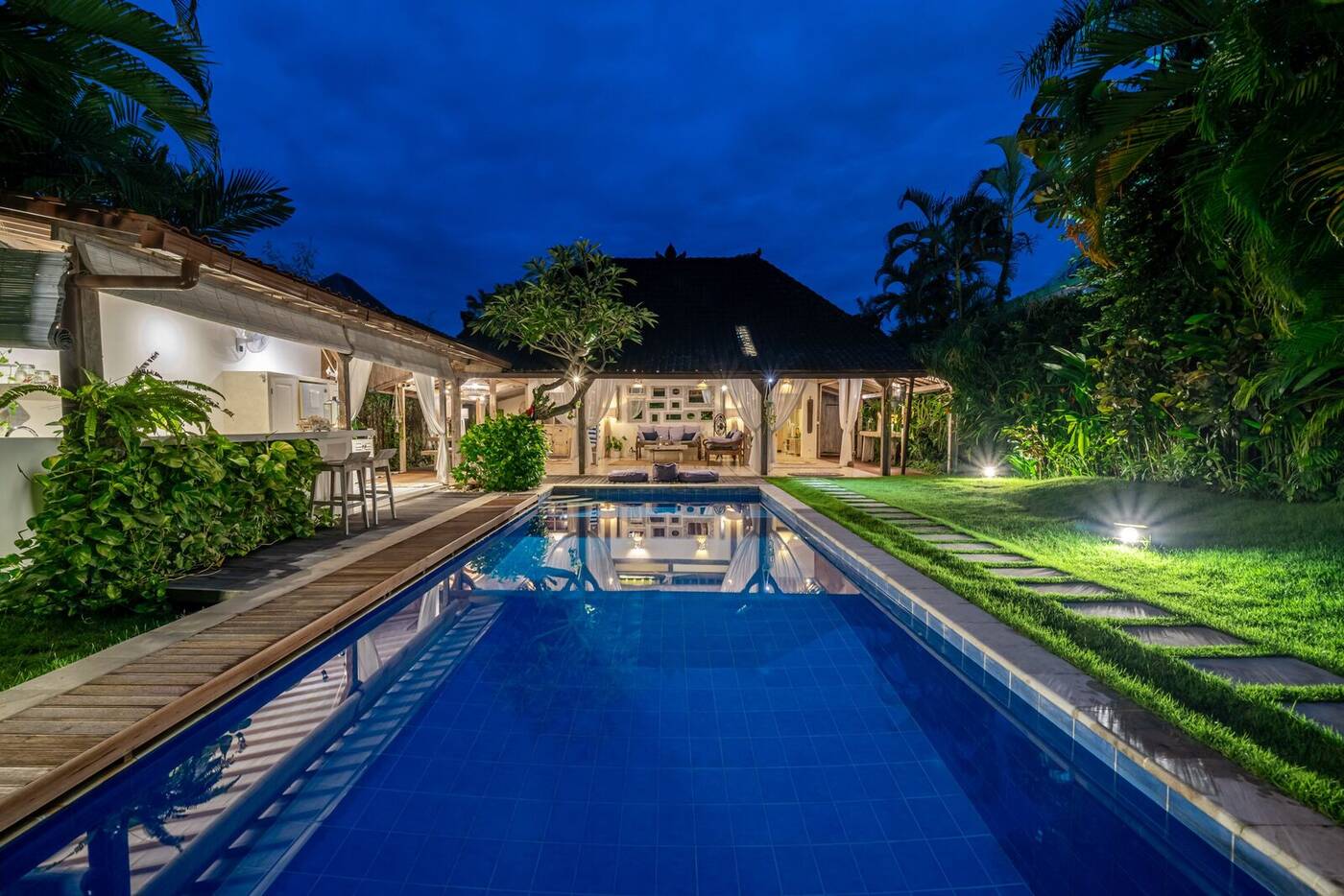 Villa Desa Naga 1 lit up at night with the pool, Canggu, Bali